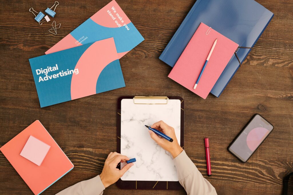 Hands of young contemporary marketer with blue highlighter over blank paper